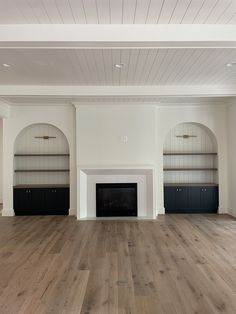 an empty living room with white walls and wood flooring is pictured in this image