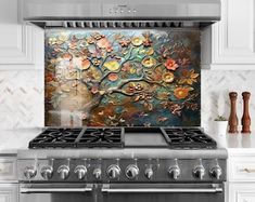 a stove top oven sitting inside of a kitchen next to a wall with flowers on it