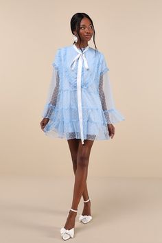 Helping you look especially sweet is what the Sister Jane Dusty Hearts Light Blue Lace Ruffled Mini Dress is an expert in! Sheer mesh fabric, with a darling heart motif throughout, shapes this swing-style, loose-fit dress that emanates whimsical vibes. Sheer long sleeves with drop shoulders and frilly flaring cuffs frame a functional partial button placket (with matching faux pearl heart-shaped buttons) and a collarless neckline, complete with a white satin necktie. Feminine ruffled trim through Mini Mesh Dress With Ruffles, Blue Mini Tulle Dresses, Blue Mesh Dresses For Spring, Blue Mesh Party Dress, Spring A-line Tulle Mini Dress, Blue Sheer Mesh Dress, Flirty Mesh Mini Dress For Spring, Feminine Long Sleeve Tulle Dress, Elegant Blue Mesh Dress For Spring