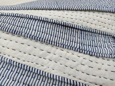 blue and white striped quilted material on top of each other