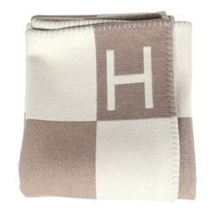 a brown and white blanket with the letter h on it