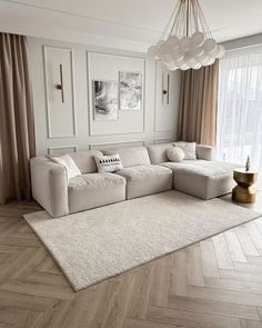 a large white couch sitting in a living room on top of a hard wood floor