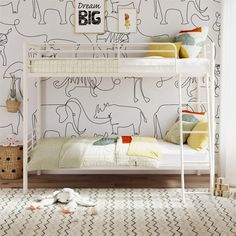 a white bunk bed sitting in a bedroom next to a wall with elephants on it