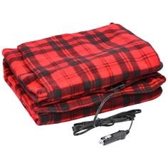 a red and black plaid blanket sitting on top of a white surface next to a charger