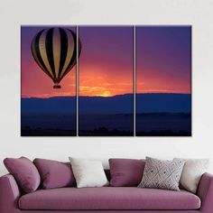 three hot air balloons flying in the sky at sunset, with mountains in the background