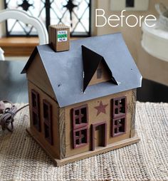 a small wooden house sitting on top of a rug