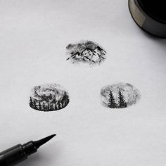 the ink drawing is being used to draw trees and mountains on paper with a pen