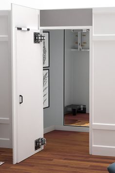 an open door in a room with wood flooring and white paint on the walls