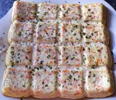 a white plate topped with lots of food on top of a blue table cloth covered in confetti