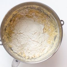 a metal pot filled with flour on top of a white counter