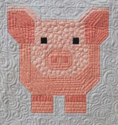 a quilted pig is shown on top of a wall hanging or table cloths