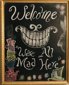 a chalkboard sign that says welcome we're all mad here