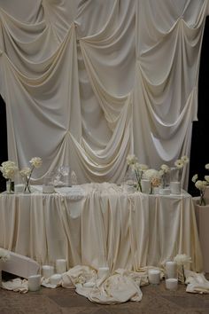 the table is covered with white flowers and cloths