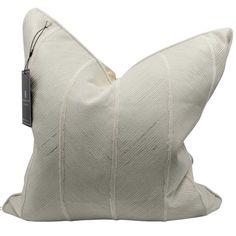 a white pillow with a black tag hanging from it's front end on a white background