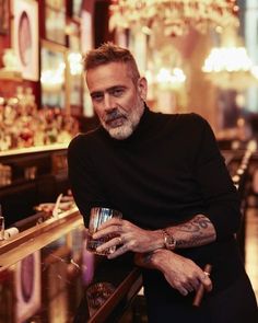 a man sitting at a bar with his arms crossed