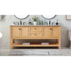 a bathroom vanity with two mirrors above it and a rug on the floor next to it