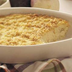 a casserole dish with crumbs in it and an apple on the side