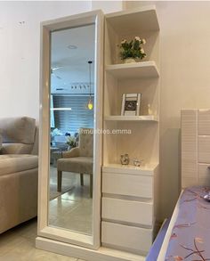 a living room with a couch, chair and book shelf