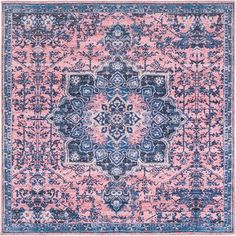 a pink and blue area rug with an ornate design on the center, in front of a