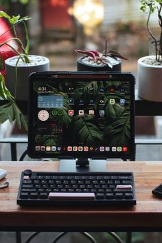 a computer monitor sitting on top of a wooden desk next to a keyboard and mouse