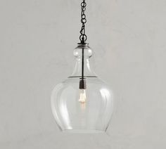 a clear glass light hanging from a chain