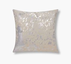 a white pillow with silver sequins on the front and back, against a gray background