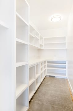 empty white shelving in a room with no one on the floor or furniture inside