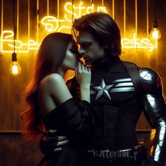 a man and woman dressed as captain america kissing in front of neon signs with lights