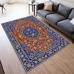 a living room with a couch and rug on the floor