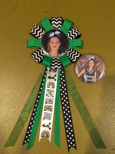 a green and black ribbon with a photo on it