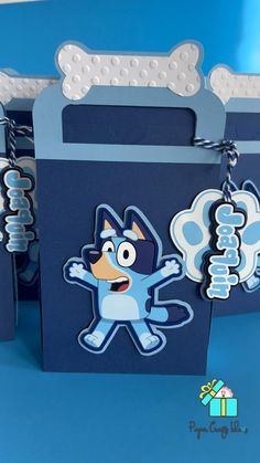 a blue bag with a cartoon character on the front and bottom, hanging from it's side