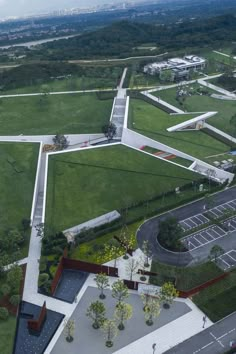 an aerial view of a parking lot and grassy area in the middle of a city