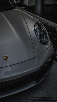 the front end of a silver sports car