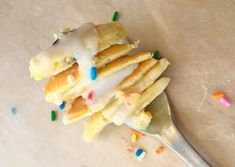 a close up of a spoon with some food on it and sprinkles