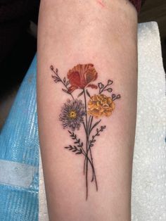 a woman's arm with flowers on it