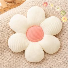 a flower shaped pillow sitting on top of a table