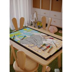 an elephant painting on a table in a child's room with chairs and toys