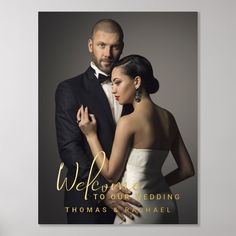 a man and woman standing next to each other in front of a sign that says welcome to our wedding