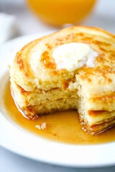 pancakes with butter and syrup on a white plate