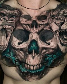 a man with tattoos on his chest is wearing a skull and two lions head tattoo