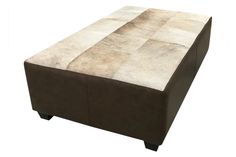 a brown ottoman sitting on top of a white floor