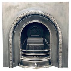 an old fashioned fireplace with silver paint on it