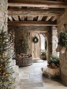 a stone house decorated for christmas with trees and wreaths