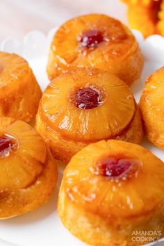 small pineapples on a white plate with orange flowers in the backgroud