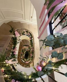 the staircase is decorated with pink and green garlands, ornaments, and ribbons that spell out the number six