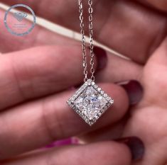 This stunning Halo Diamond Necklace features a brilliant 1.50 carat Princess Created Diamond, set in a delicate 925 sterling silver pendant. The 1 carat Round Cut Created Diamond adds extra sparkle and elegance to make this the perfect gift for any special occasion. Expertly crafted for maximum beauty. Chain Size: 18" (45.7 cm) including the clasp Pendant Size: 1.1 cm X 1.1 cm Main Stone Size: 7 mm X 7 mm (1.5 Carat) Main Stone Color: Clear White Main Necklace Color: Silver Main Stone Shape: Pri Wedding Solitaire Square Pendant Necklace In Sterling Silver, Luxury Silver Necklace Gia Certified, Sterling Silver Square Pendant Solitaire Necklace For Wedding, Gia Certified Moissanite Jewelry As A Gift, Gia Certified Diamond White Jewelry Gift, Sterling Silver Solitaire Necklace With Square Brilliant Cut, White Gold Princess Cut Necklace For Anniversary, Princess Cut White Gold Necklace For Anniversary, Sterling Silver Princess Cut Diamond Necklace