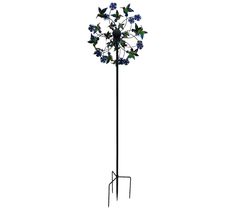 a tall metal plant with blue flowers on it