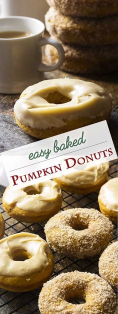 baked pumpkin donuts with icing on a cooling rack and cup of coffee in the background