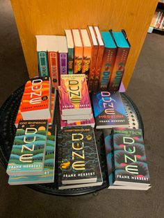 a table topped with lots of books on top of a black tray