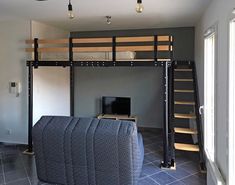 a loft bed with a couch underneath it